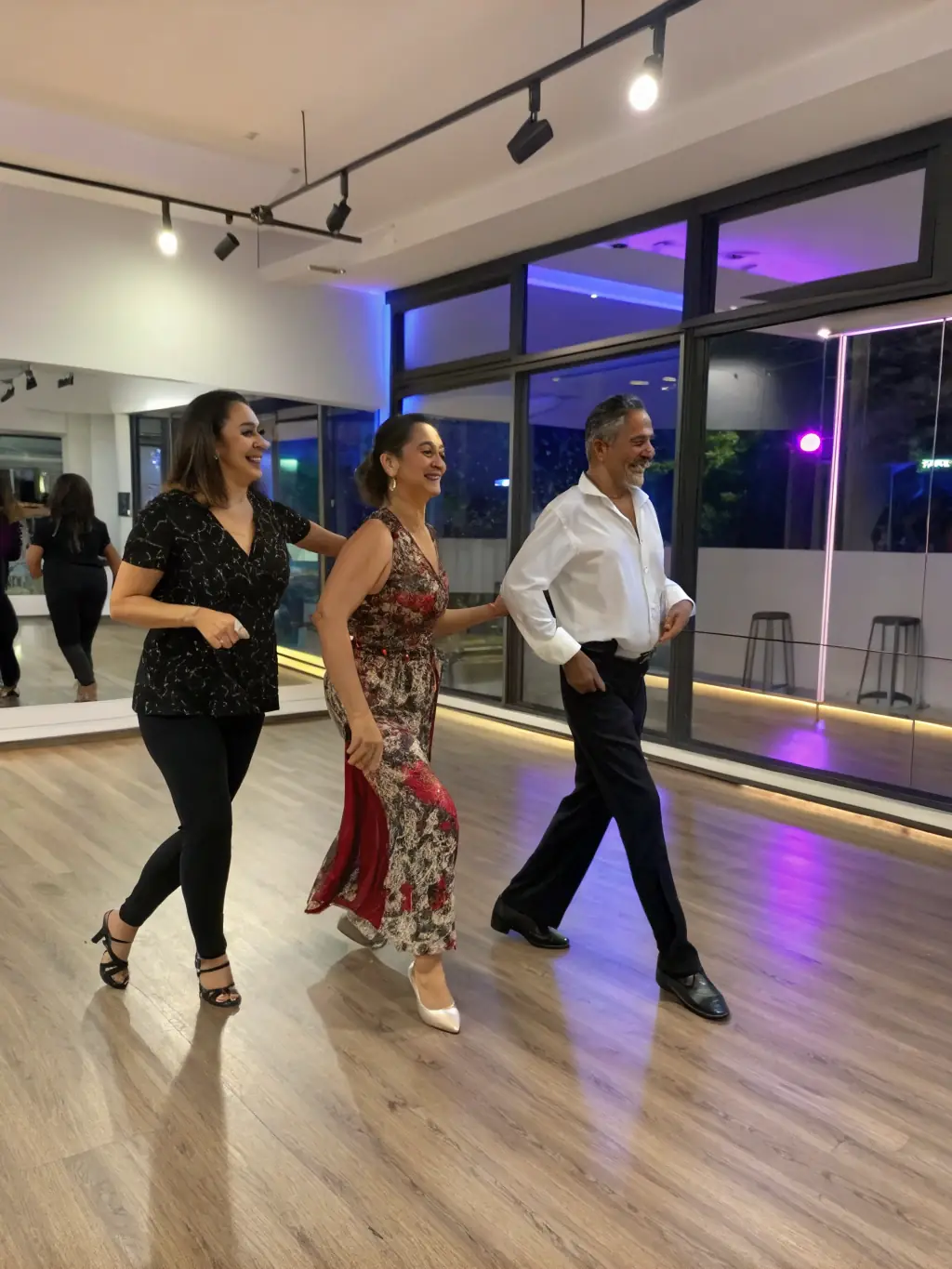 A photograph of adults learning traditional dance steps during a cultural dance class, emphasizing the organization's role in preserving and promoting local cultural heritage.